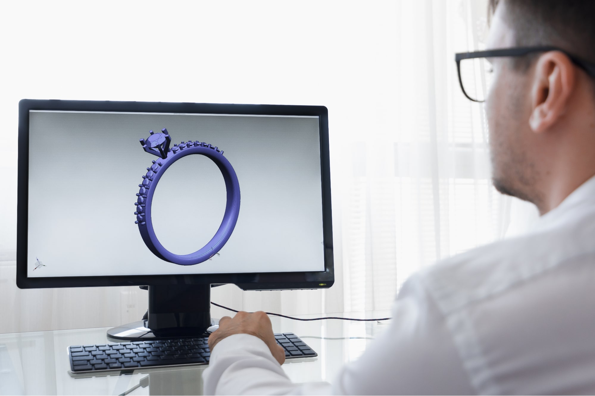 jewelry designer working on a custom design on a computer