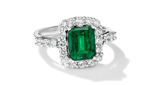 an emerald cut emerald fashion ring with a diamond halo