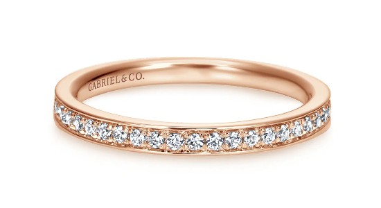 a rose gold wedding band with channel set diamonds