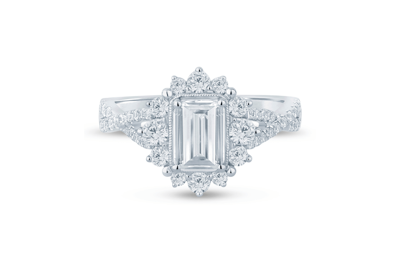 A vintage inspired emerald semi-mount engagement ring in white gold.