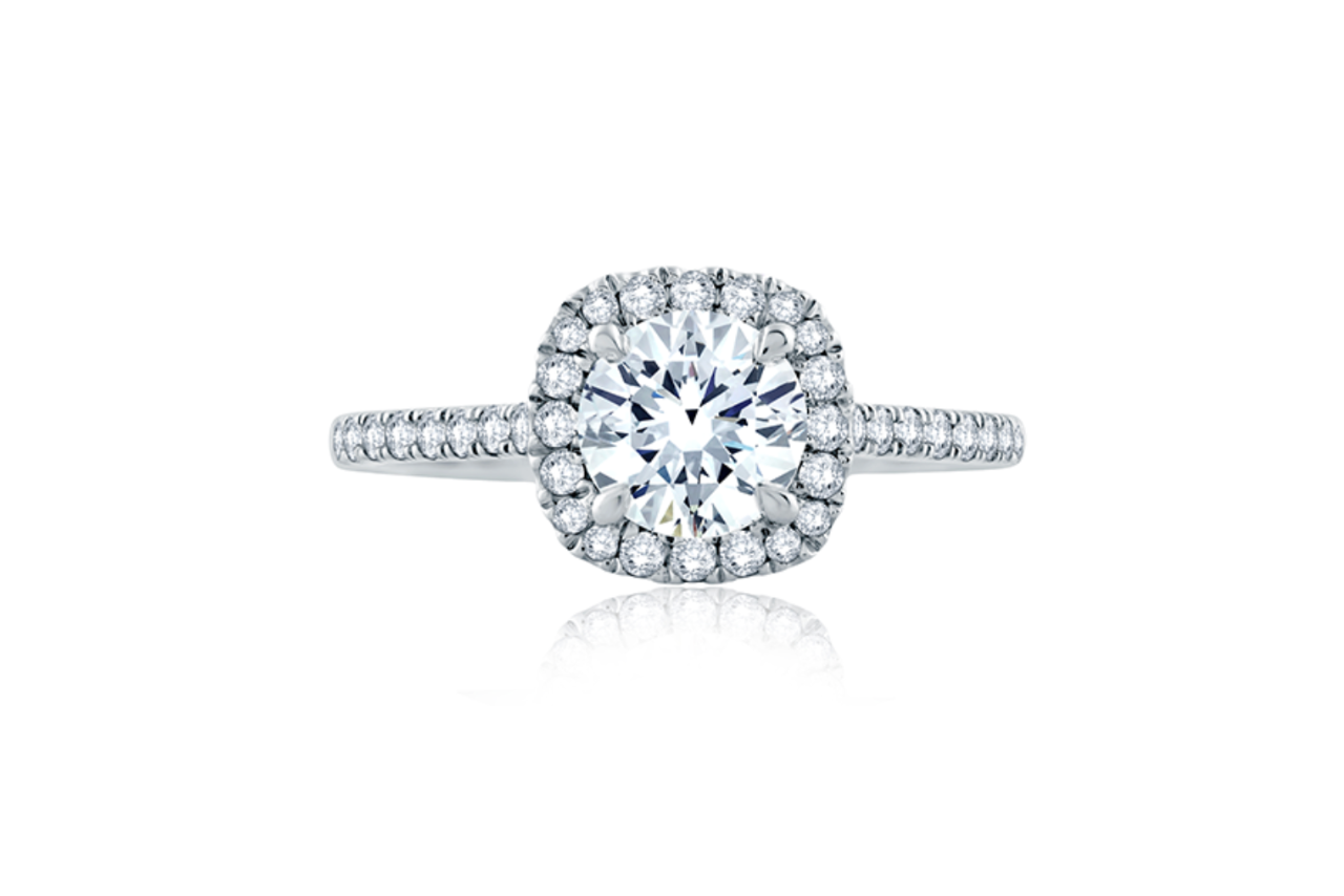 A classic diamond round engagement ring with a square halo and a diamond band.