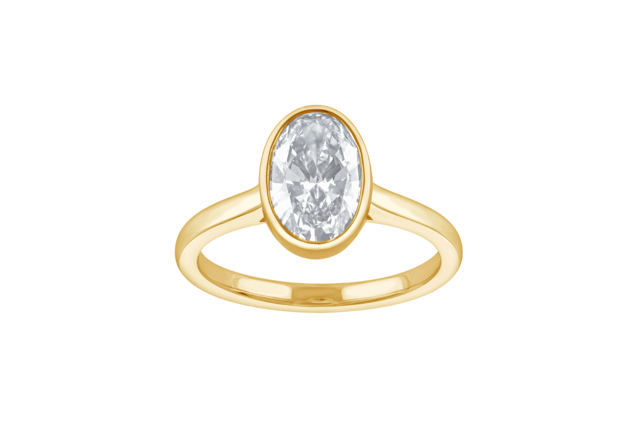 A yellow gold oval engagement ring in a bezel setting.