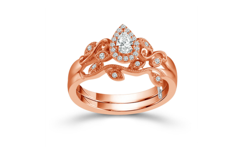 An elegant floral engagement ring with a pear cut center diamond from Morgan’s Collection.