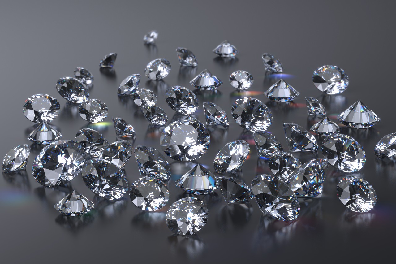 A selection of diamonds on a dark grey surface