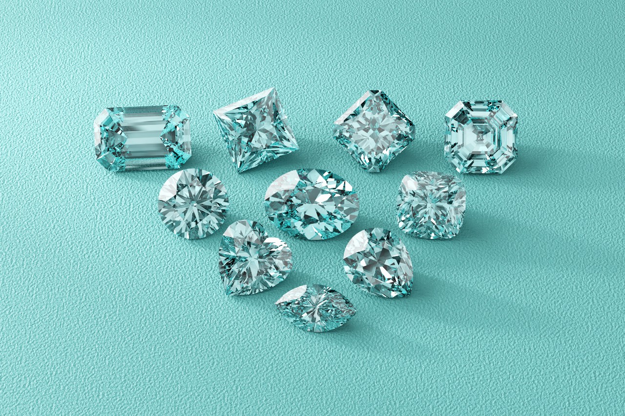 A collection of ten sparkling aquamarine gemstones in various cuts, elegantly arranged on a textured turquoise surface