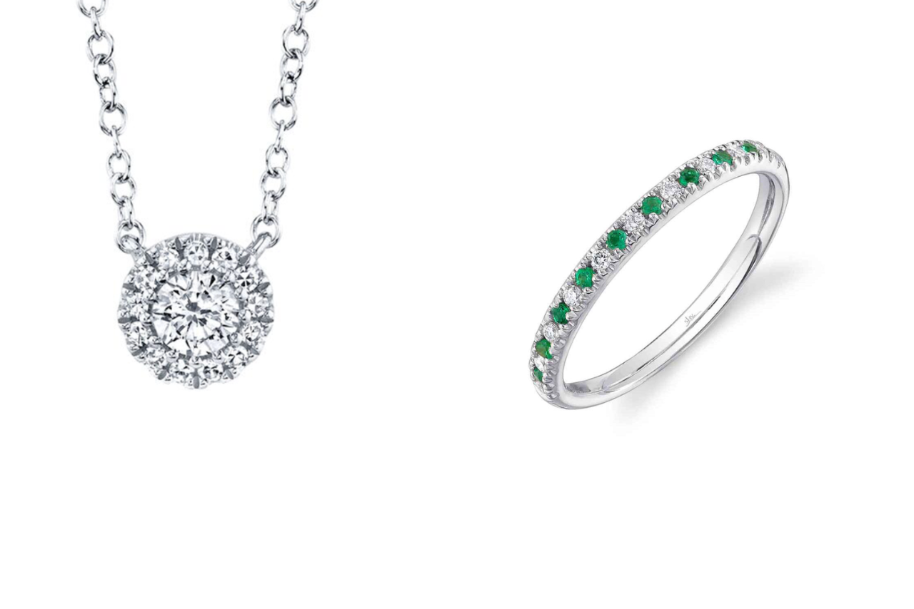 A dazzling diamond pendant necklace with a circular center stone, paired with a diamond band with hints of emerald throughout the ring.