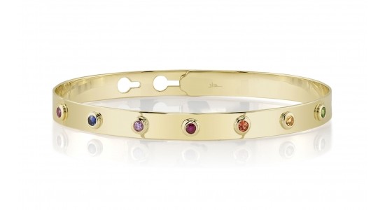 A yellow gold bangle bracelet with multicolored stones from Shy Creation, available at Morgan Jewelers.