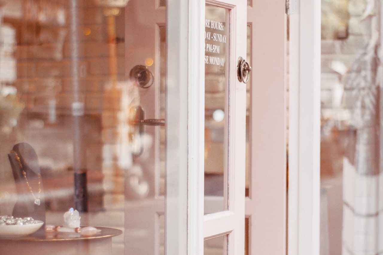A view of a jewelry store entrance, the door welcomely ajar.