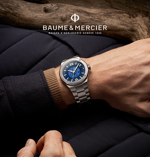 A hand with a watch on the wrist with text Baume and Mercier.