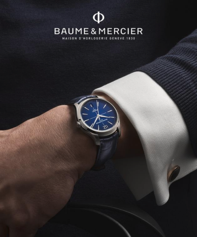 A hand with a watch on the wrist with text Baume and Mercier.