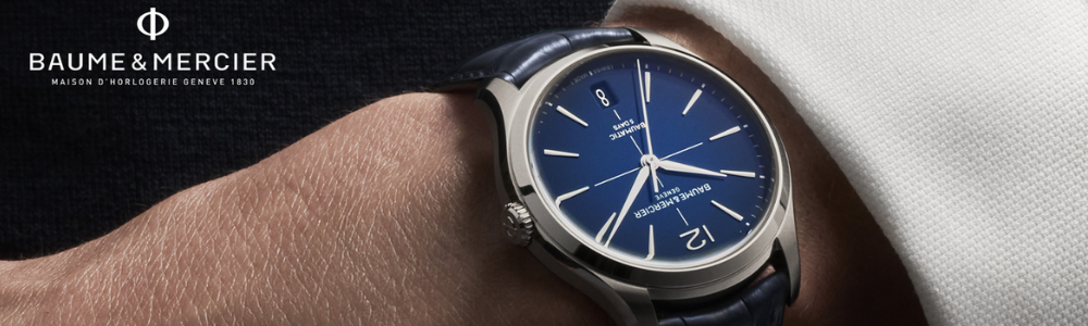 A hand with a watch on the wrist with text Baume and Mercier.
