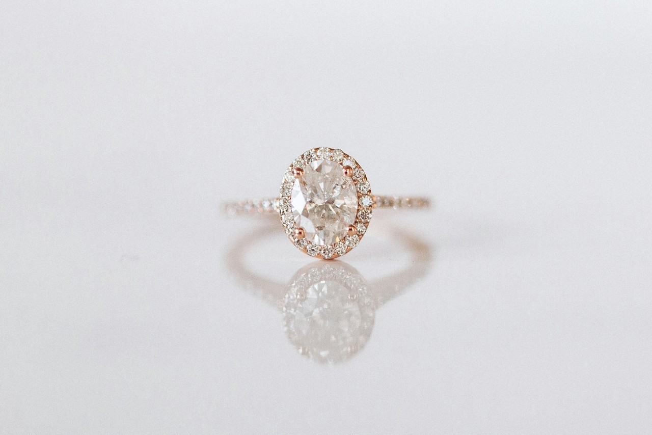 A rose gold diamond engagement ring with oval cut diamond