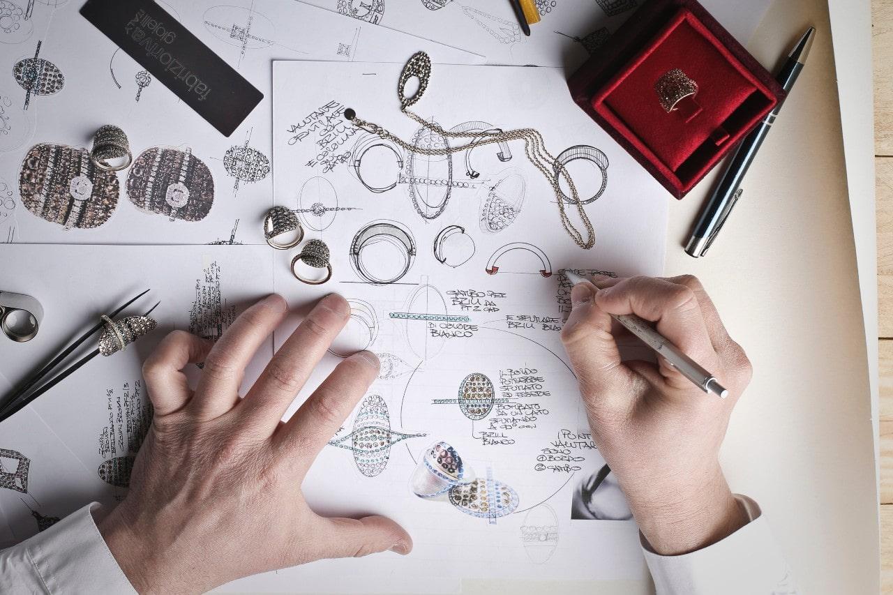 a jeweler drawing out plans for custom designed jewelry 