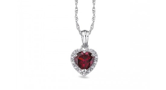 a white gold pendant necklace featuring a heart shaped ruby surrounded by diamonds
