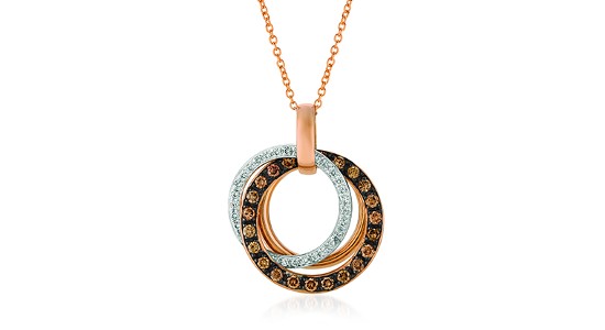 a mixed metal pendant necklace featuring three interlocking rings
