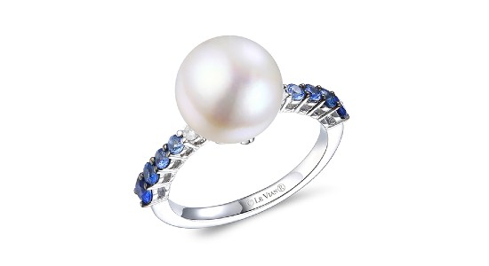 a white gold fashion ring featuring a large pearl center stone and ombre colored sapphires